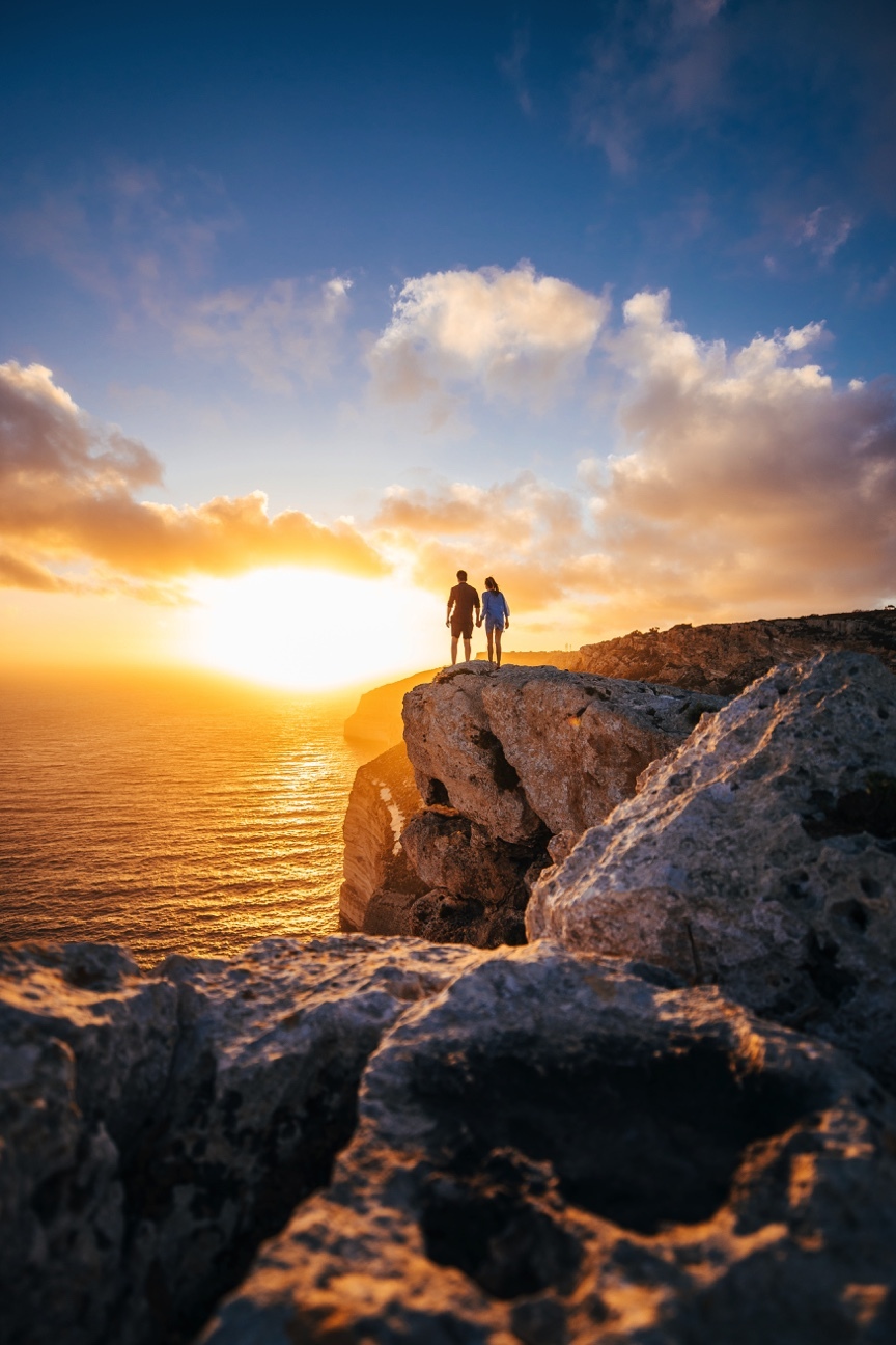 Couple on cliffs of Malta at Sunset